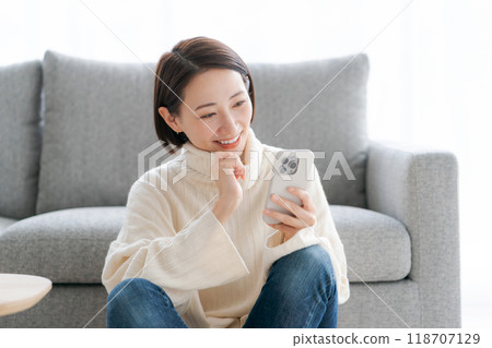 Woman operating a smartphone Woman operating a smartphone 118707129