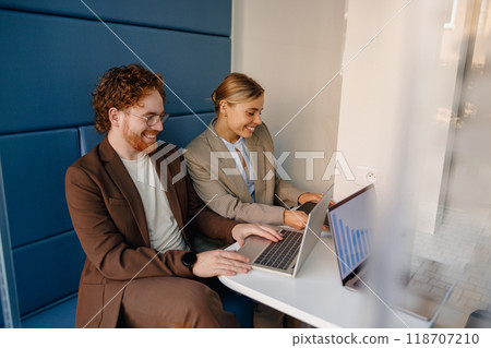 A Collaborative Work Environment Featuring Professionals Engaged with Laptops and Technology 118707210