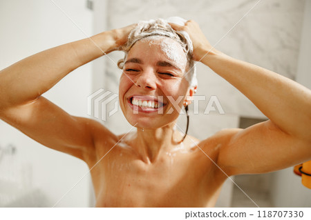 A Joyful Woman Enjoying Washing Her Hair in a Beautiful and Modern Shower Setting 118707330