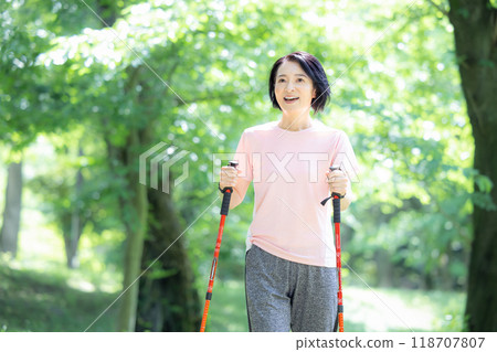 Middle-aged woman enjoying walking Middle-aged woman enjoying walking 118707807