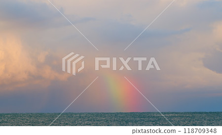 Beautiful Sea Landscape. Rainbow Under The Clouds Over Sea. Weather After Rain. Static view. Beautiful Sea Landscape. Rainbow Under The Clouds Over Sea. Weather After Rain. Static view. 118709348