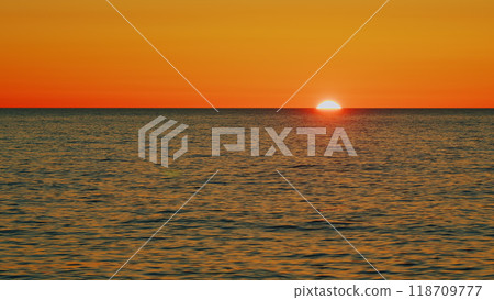 Beautiful Sunset Above Sea. Sunrays Flickering In Ripples On Water Surface. Natural Sky Reflects In Sea Warm Colors. Slow motion. 118709777