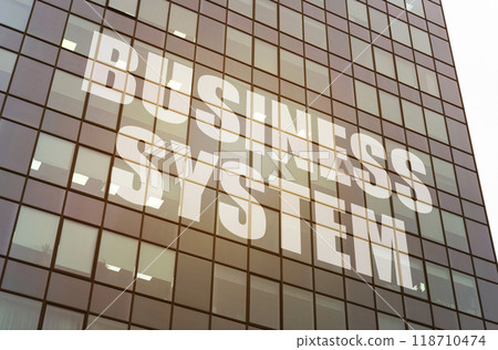 On the glass surface of the business center there is an inscription - Business System On the glass surface of the business center there is an inscription - Business System 118710474