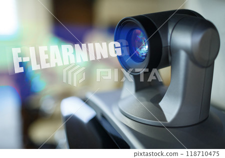 A blue beam glows from the projector inside which is the inscription - E-LEARNING A blue beam glows from the projector inside which is the inscription - E-LEARNING 118710475
