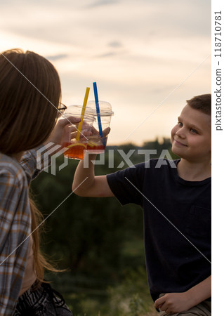 A plastic cup with bubble tea is in the woman's hand A plastic cup with bubble tea is in the woman's hand 118710781