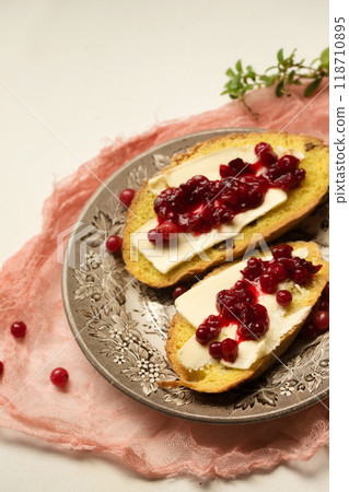 Cornbread with butter and lingonberry jam 118710895