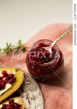 Lingonberry jam on pink cheesecloth 118710896