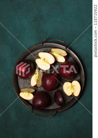Juicy red apples in a vintage tray on a green background Juicy red apples in a vintage tray on a green background 118710922