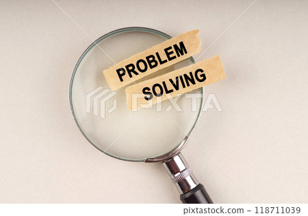 On the magnifying glass are paper strips with the inscription - PROBLEM SOLVING On the magnifying glass are paper strips with the inscription - PROBLEM SOLVING 118711039