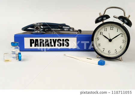 On a white surface, a thermometer, a stethoscope and a folder with the inscription - Paralysis On a white surface, a thermometer, a stethoscope and a folder with the inscription - Paralysis 118711055