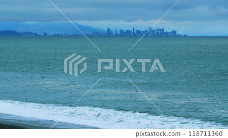 Skyscrapers On The Shore Of The Bay. Seascape With Dark Rain Clouds Moving In Overcast Grey Sky. Still. Skyscrapers On The Shore Of The Bay. Seascape With Dark Rain Clouds Moving In Overcast Grey Sky. Still. 118711360