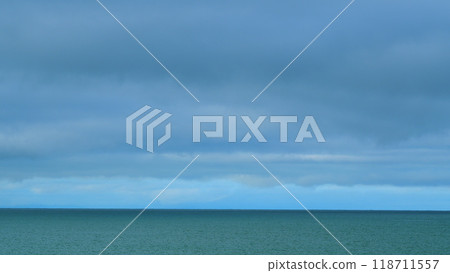 Seascape With Dark Rain Clouds Moving In Overcast Grey Sky Over A Sea Horizon During Bad Weather. Still. Seascape With Dark Rain Clouds Moving In Overcast Grey Sky Over A Sea Horizon During Bad Weather. Still. 118711557