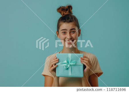 Happy birthday girl with a gift in her hands on a blue background 118711696