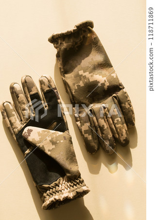 Men's army gloves of protective color on a beige background 118711869