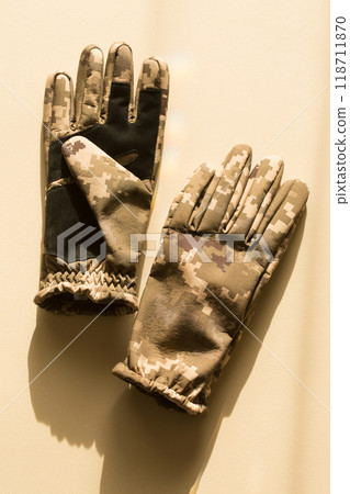Men's army gloves of protective color on a beige background 118711870