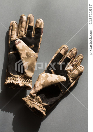 Army gloves of protective color on a gray background 118711957