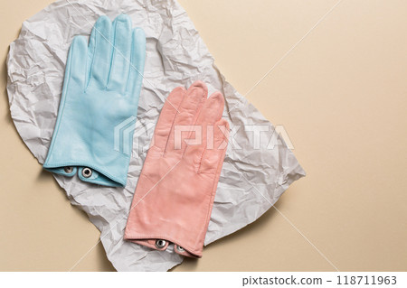 A creative multi-colored pair of gloves on on crumpled paper A creative multi-colored pair of gloves on on crumpled paper 118711963