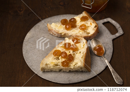 Homemade bread, butter and yellow cherry jam. Still life in a rustic style 118712074