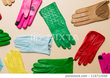 Fashionable gloves on a beige background 118712098