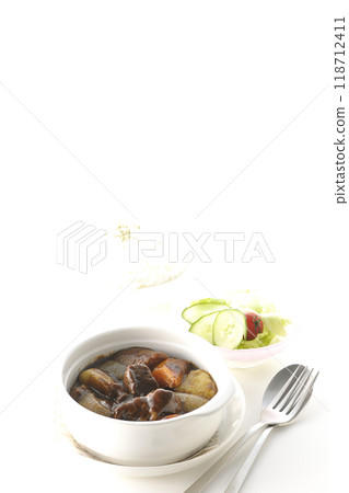 A set of beef stew with chunks of meat and vegetables, rice and salad A set of beef stew with chunks of meat and vegetables, rice and salad 118712411