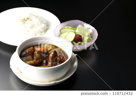 A set of beef stew with chunks of meat and vegetables, rice and salad A set of beef stew with chunks of meat and vegetables, rice and salad 118712432