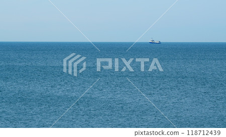 Fishing Boat On The Horizon At Sea. Abstract Small Waves On Calm Water Surface In Motion. Real time. 118712439