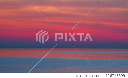 Beautiful Sunset Above Sea. Sun Sets Turning Purple Or Pink And Violet Tones And Reflects In Ocean. 118712899