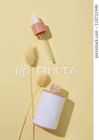 Cosmetic oil in a bottle with dried flowers Cosmetic oil in a bottle with dried flowers 118712946