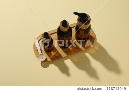 Cosmetic oil in a brown bottle on a light background 118712949