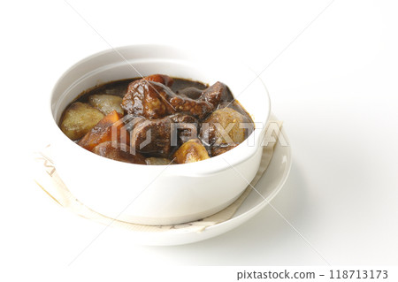 Beef stew with chunky vegetables photographed on white background 118713173
