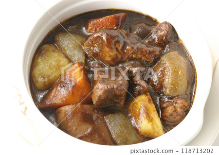 Beef stew with chunky vegetables photographed on white background 118713202
