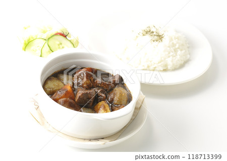 A set of beef stew with chunks of meat and vegetables, rice and salad A set of beef stew with chunks of meat and vegetables, rice and salad 118713399