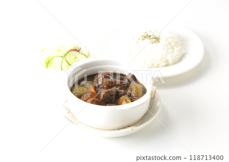 A set of beef stew with chunks of meat and vegetables, rice and salad 118713400