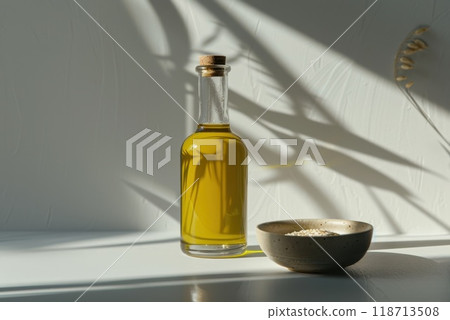 Sesame oil in a bottle and sesame seeds in a plate on the table 118713508