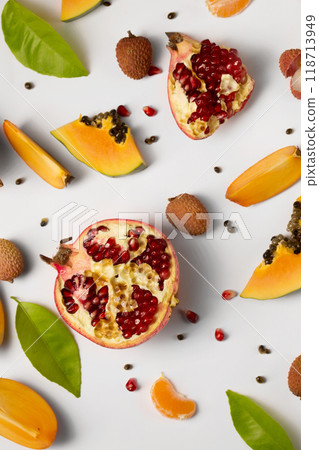 Fruit background made of pieces of ripe papaya, garnet and litchi on a white background 118713949