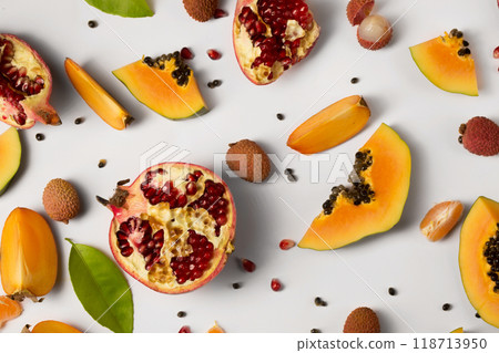 Fruit background made of pieces of ripe papaya, garnet and litchi 118713950