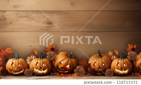 Jack-o'-Lanterns and Autumn Leaves on Wooden Background 118715372