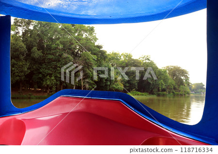 The picture in the foreground is the window of the boat. The picture in the foreground is the window of the boat. 118716334
