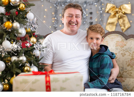 Father and son on sofa in Christmas interior 118716784