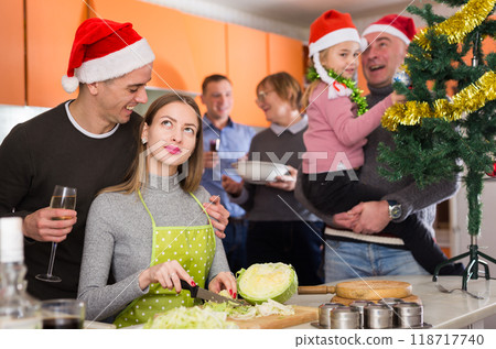 Woman cooking for Christmas dinner, happy family in kitchen Woman cooking for Christmas dinner, happy family in kitchen 118717740