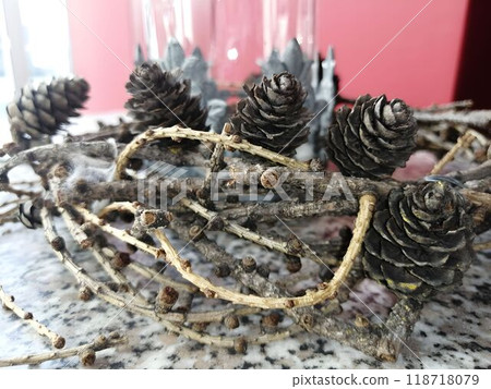 Close-Up of Pine Cones and Twigs on Textured Surface Close-Up of Pine Cones and Twigs on Textured Surface 118718079