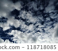 Dynamic Cloud Formation Against Dark Blue Sky 118718085