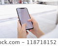 Hand holding smartphone mockup of blank screen, Take your screen to put on advertising. 118718152