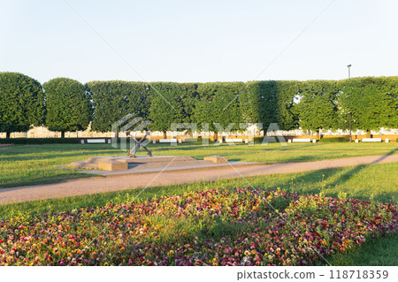 background, coastal park landscape with paths, benches and and an old anchor on a pedestal background, coastal park landscape with paths, benches and and an old anchor on a pedestal 118718359