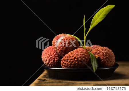 Small ripe tropical lychee berries in a minimalist style, low key Small ripe tropical lychee berries in a minimalist style, low key 118718373