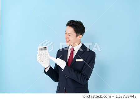 Man wearing white gloves holding a calculator Man wearing white gloves holding a calculator 118719442