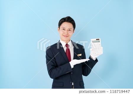 Man wearing white gloves holding a calculator 118719447