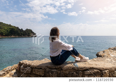 Woman Admiring Coastal View on a Sunny Day Woman Admiring Coastal View on a Sunny Day 118720550
