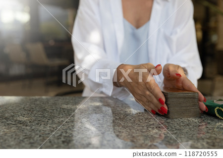 Young woman holding tarot cards.  118720555