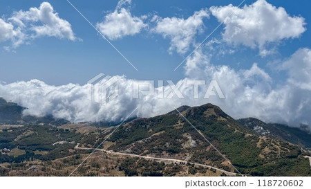 Mountainous Landscape with Rolling Clouds 118720602